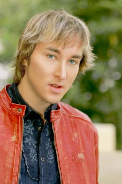 Portrait of Michael Alden wearing a red leather jacket