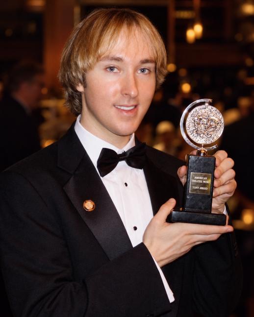 Michael Alden holding a Tony Award